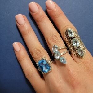 Blue topaz rings sold separately .